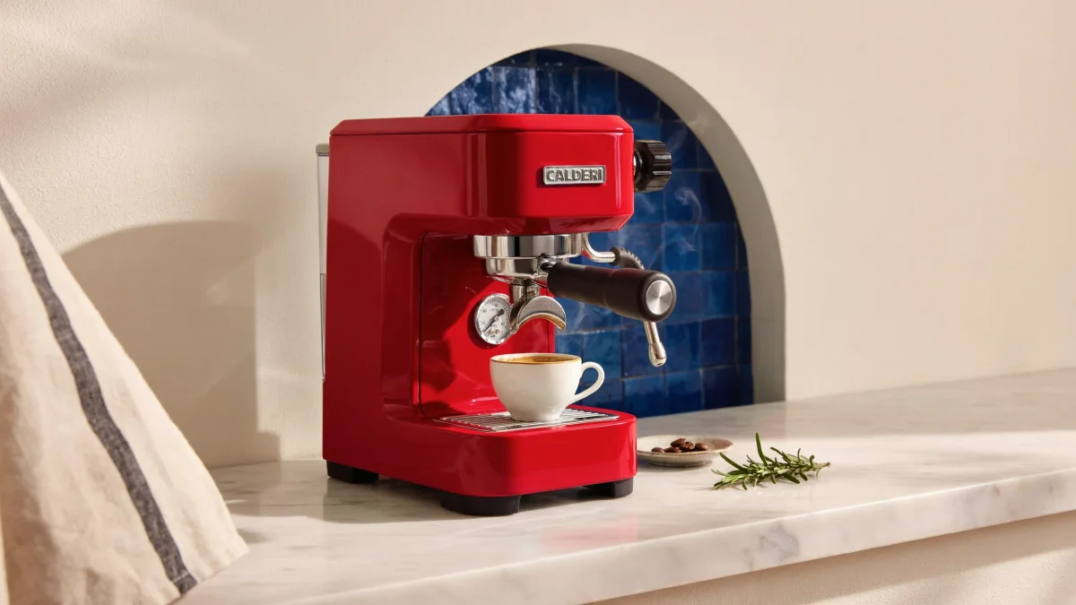 Cherry-red espresso machine in a blue tiled niche