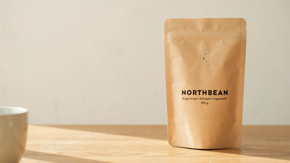 Kraft coffee pouch with a NORTHBEAN label on an oak table